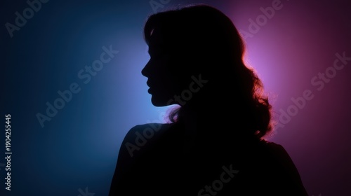Silhouette of a woman's head and shoulders. the woman is facing away from the camera, with her head turned slightly to the side.