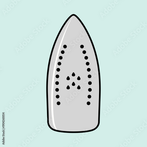 Close-up of an iron soleplate with steam holes on a light blue background