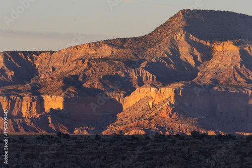 A scenic view of warm sunset light on a high desert canyon in Abiquiu, New Mexico. 