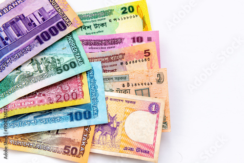 A close up of the Bangladesh currency isolated on white, showing the entire range of bank notes from 1 to 1000 Taka.