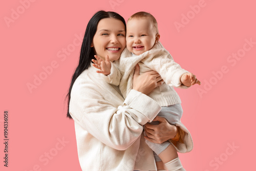 Happy young mother hugging ...