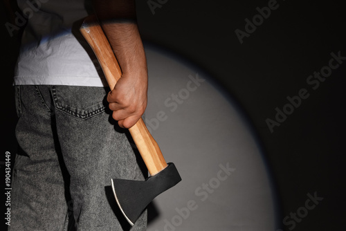 Man holding ax on grey back...