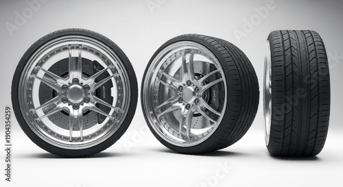 Three car tires with different views and rims on a white background.