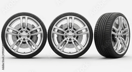 Three car tires with silver alloy wheels on white background.