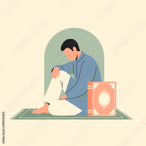 Man sitting on a prayer mat reading a book.