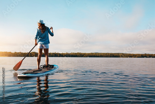Obraz na plátne Holiday, back of woman and paddle boarding on lake for vacation activity, adventure and hobby