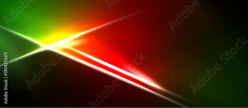 Abstract vibrant light streaks intersect. Green, red, yellow hues dominate dark background. Dynamic energy radiates from central point.