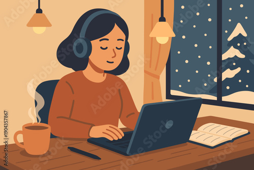 Person uses laptop at home during winter with coffee and notebook nearby