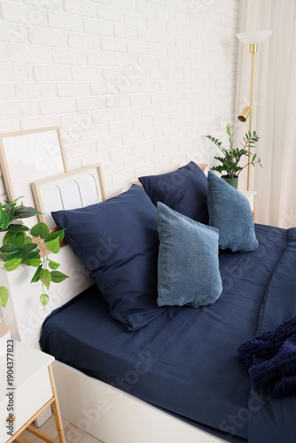 Bed with stylish blue beddi...