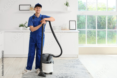 Young male janitor with mod...