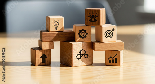 Wooden blocks stacked with business strategy icons.
