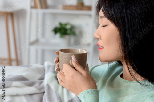 Young Asian woman with warm...