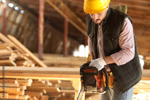 Young carpenter in hardhat ...
