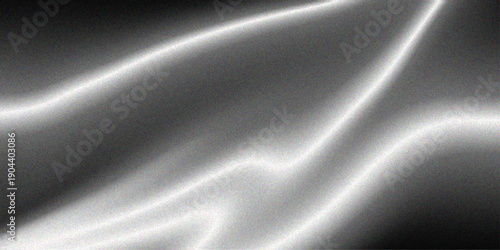 Smooth flowing black and white abstract background featuring a luxury silk fabric texture with soft light waves and a dark satin motion design