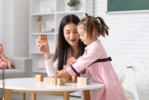 Female teacher with cubes a...