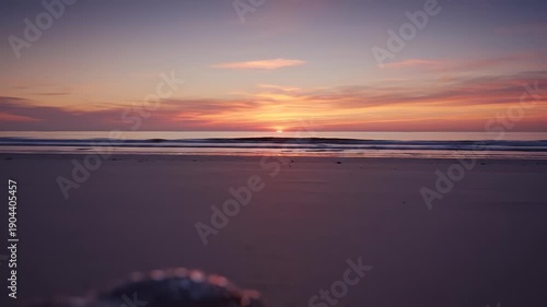 Sunglasses and Seashells on Beach at Sunset.