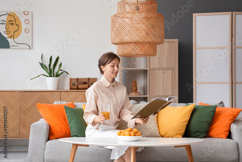 Young woman with glass of a...