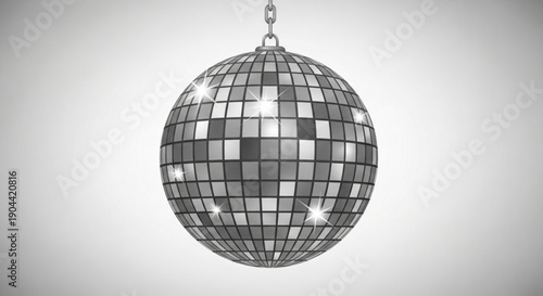 Disco ball hanging from a chain on a gray background with shiny mirrored tiles reflecting light