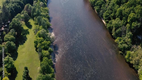 Wallpaper Mural Top-down aerial drone shot flying over the green banks of the Dordogne river near Limeuil, capturing the contrast between lush vegetation and flowing water. Torontodigital.ca