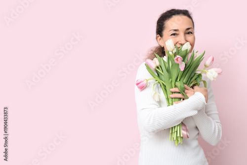 Mature woman with bouquet o...