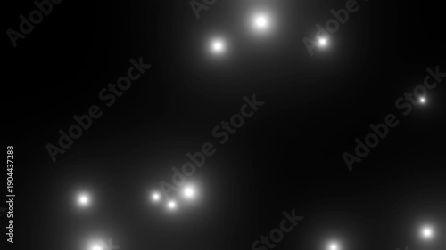黒背景の上を飛ぶたくさんの白い粒子