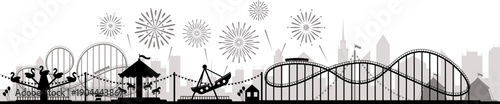 Amusement park rides with fireworks in city skyline silhouette