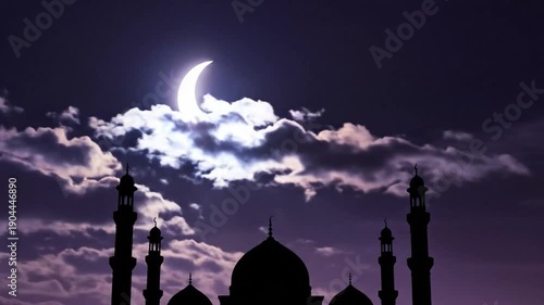 Mosque silhouette at night. Ramadhan kareem. Ramadhan mubarak. Moonlit sky with clouds. Dark purple and pink hues. Islamic architecture. Crescent moon. Nighttime scene. Religious building.