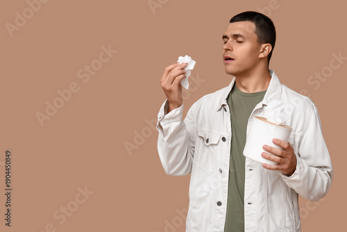 Ill young man with tissues ...