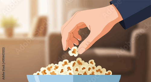 A hand reaches into a blue bowl of popcorn on a couch