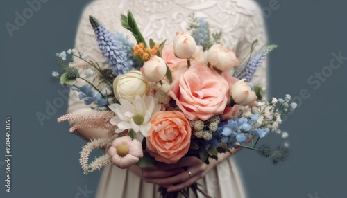 Elegant wedding flower bouquet in past colors held by bride