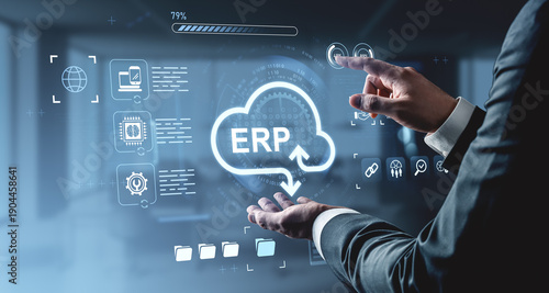 Businessman using virtual ERP interface with cloud computing icons on digital futuristic background for enterprise resource planning concept.