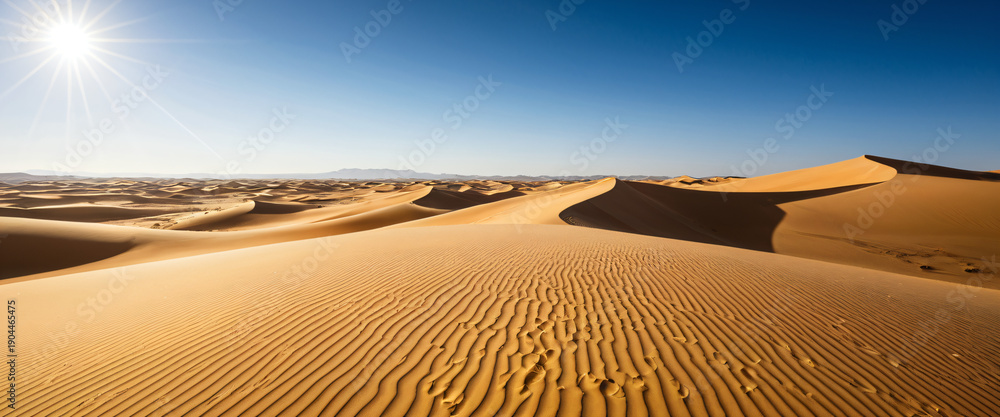 Naklejka premium Desert dunes with wind patterns and clear sky