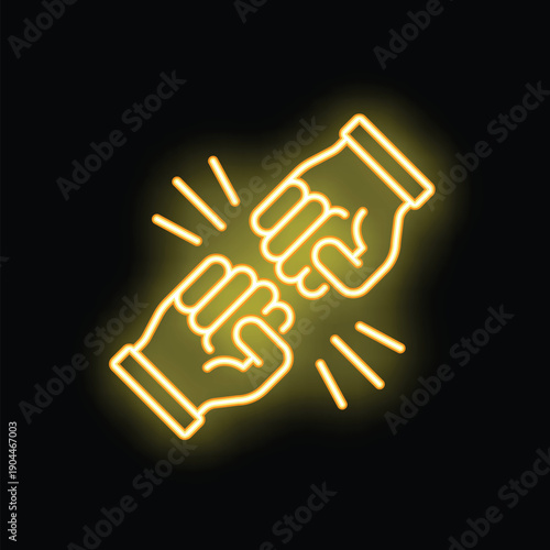 Yellow glowing neon sign showing two fists bumping on a brick wall representing partnership and success