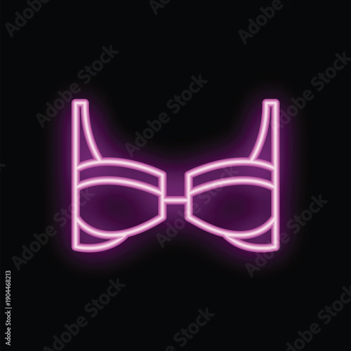 Bright pink neon sign is glowing on a black background showing a woman's bra