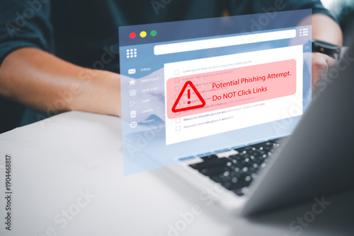 Obraz na płótnie Businessman using laptop with potential phishing attempt warning pop-up on email interface