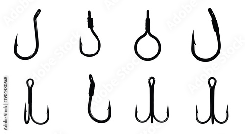 Collection of various black fishing hooks displayed on a white background