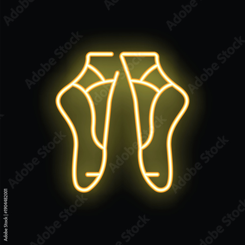 Yellow neon sign showing a pair of ballet pointe shoes glowing on a black background