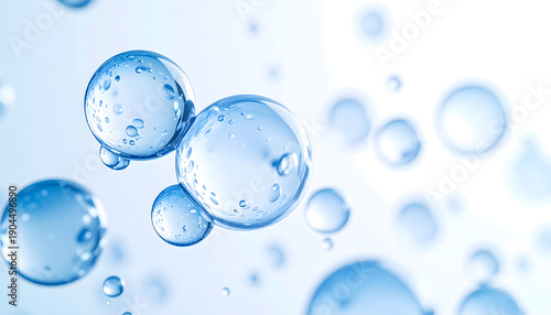 Close-up of blue water bubbles with small droplets, suspended in a light blue background, macro detail, stock media.