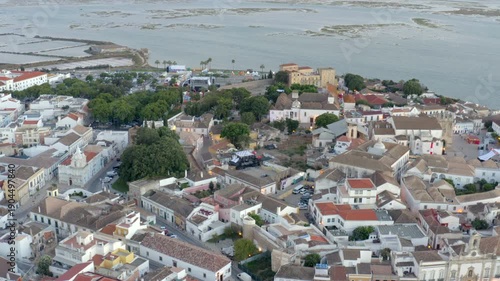 Faro city aerial left to right sweep of old town and lagoon Portugal