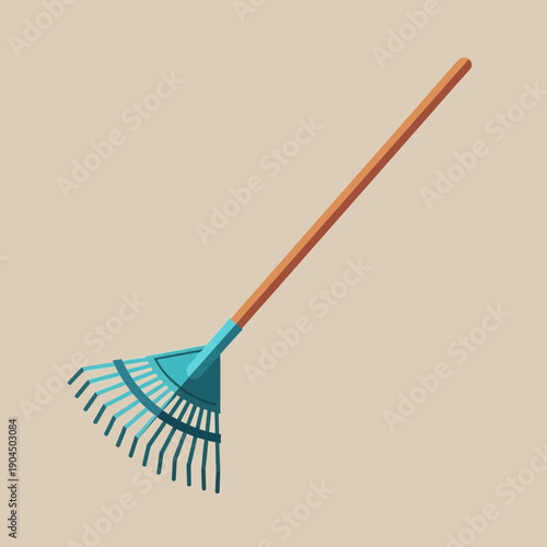 Garden rake with wooden handle on beige background