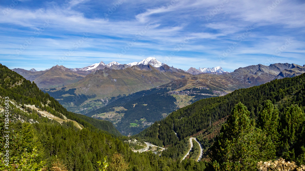 Obraz premium Mountain landscape with country road, green forests and Mont Blanc in the background, Savoyen, France, Europe.
