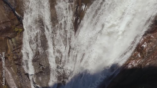 Top View Of Plunges Over Steep Rock Granite Cliff. Ezaro Waterfall In Galicia, Spain. Aerial Shot