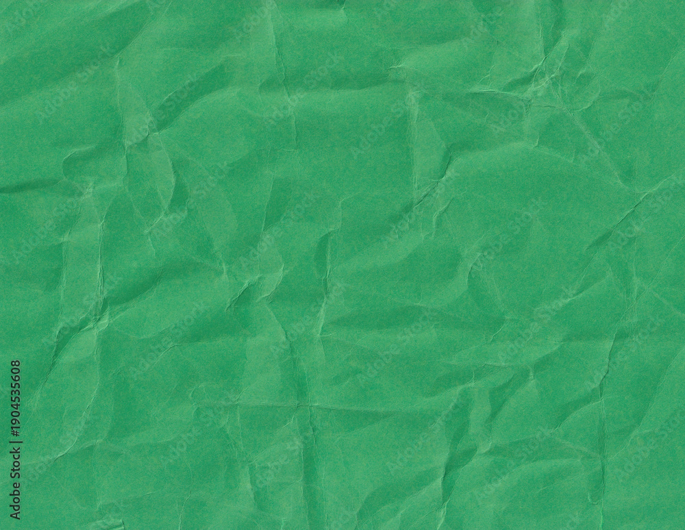Fototapeta premium Texture of crumpled paper in green color creates an interesting background for various designs or artistic projects