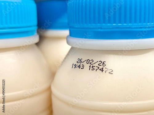 Select focus of the expiration date stamped on milk bottle. Expire date. Dairy product. For manufacturing, quality control, packaging design, consumer goods, and product labeling