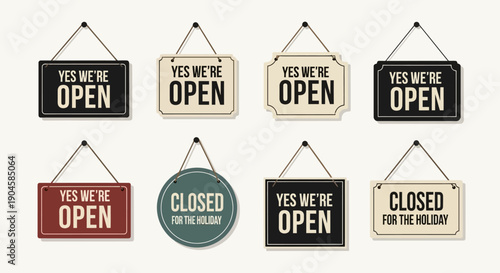 Collection of hanging open and closed signs on white background