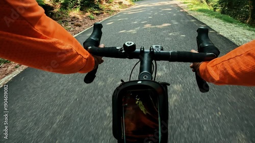 POV road cycling on winding forest mountain road in the French Alps