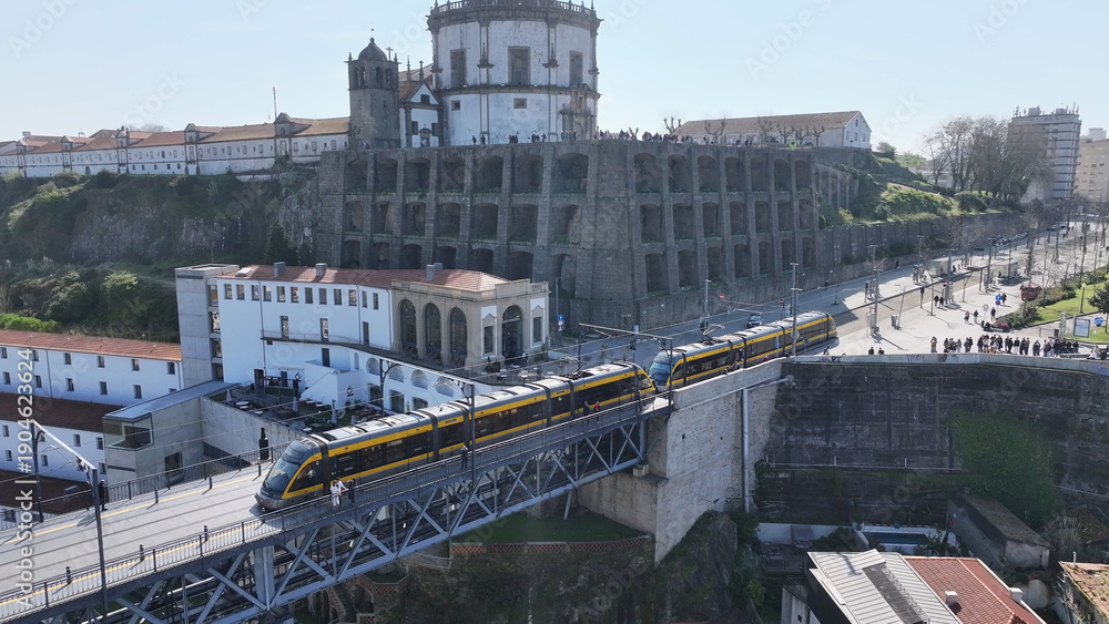Obraz premium Dom Luis I Bridge In Porto Portugal. Traffic Is Moving Across A Modern Cable(Stayed Bridge. Metropole Landscape Company Building Vibrant. Metropole Corporate Town. Porto Portugal.