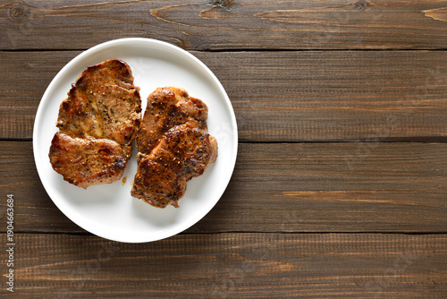 Juicy grilled pork steaks on plate