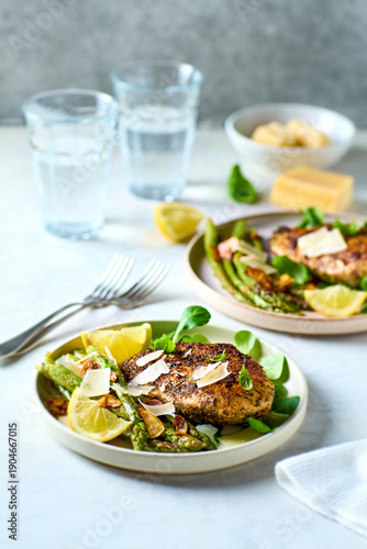 Baked chicken breast with green asparagus and parmesan