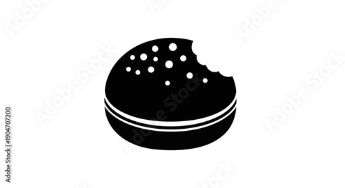Black cookie with white sprinkles and a bite taken out.